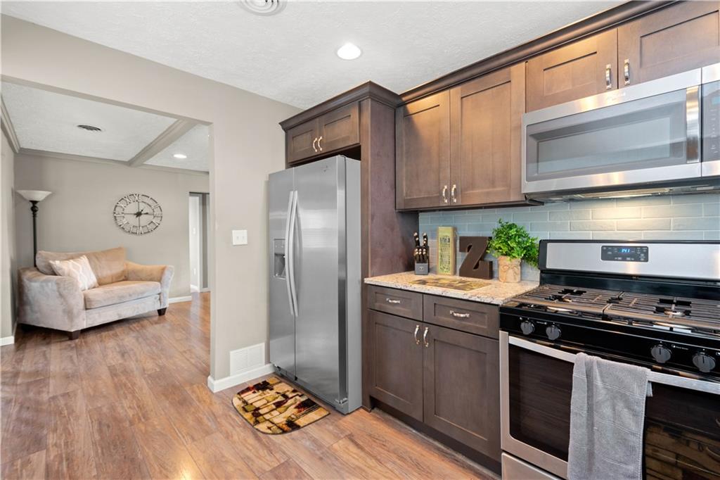 133 Baker Rd Extension Monaca, PA 15061 - Photo 12 of 25 a kitchen with stainless steel appliances granite countertop a stove a sink and a refrigerator