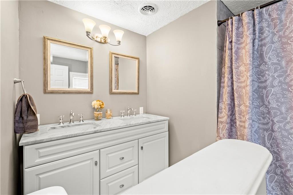 133 Baker Rd Extension Monaca, PA 15061 - Photo 19 of 25 a bathroom with a sink and a mirror