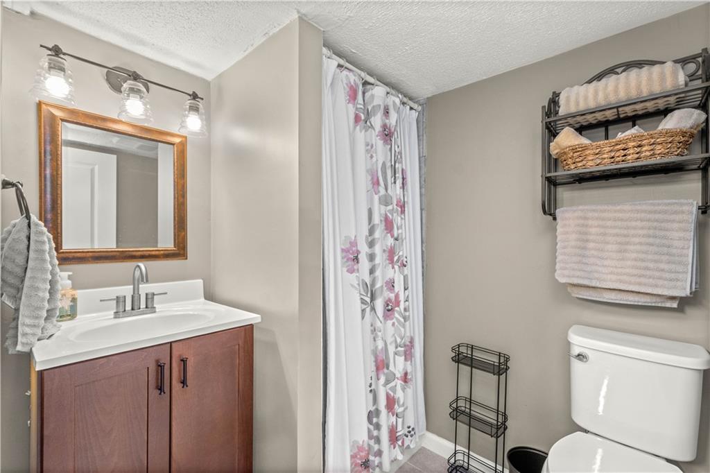 133 Baker Rd Extension Monaca, PA 15061 - Photo 21 of 25 a bathroom with a sink a toilet and shower
