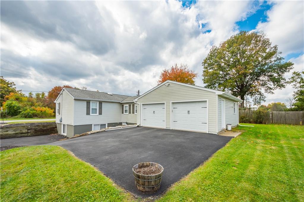 133 Baker Rd Extension Monaca, PA 15061 - Photo 4 of 25 a view of a house with a yard and a large tree