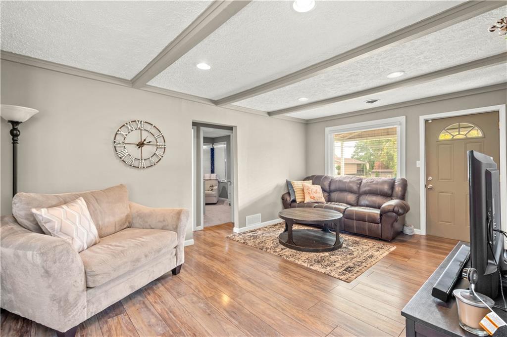 133 Baker Rd Extension Monaca, PA 15061 - Photo 8 of 25 a living room with furniture wooden floor and a large window