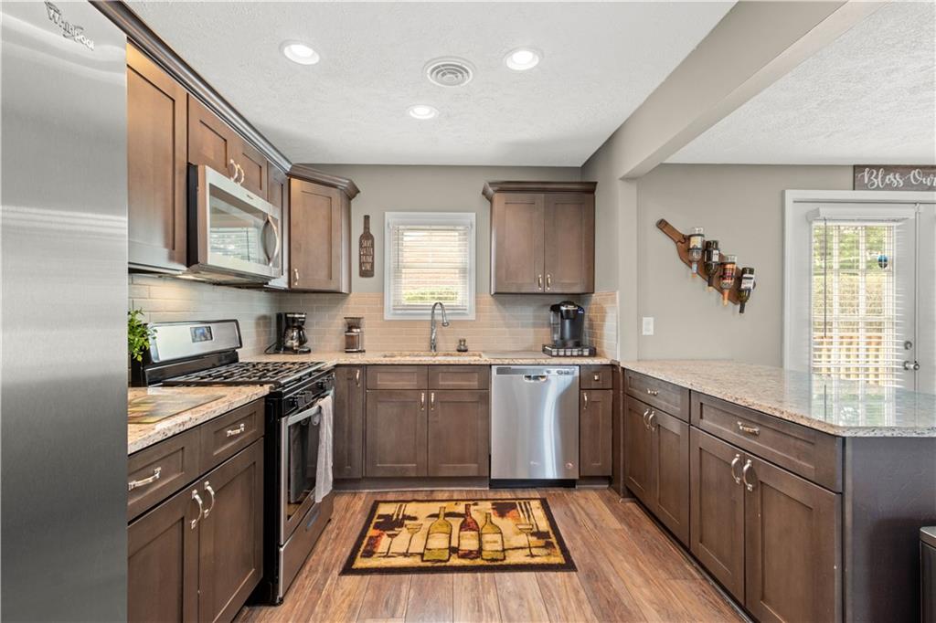 133 Baker Rd Extension Monaca, PA 15061 - Photo 9 of 25 a kitchen with stainless steel appliances granite countertop a stove sink and cabinets