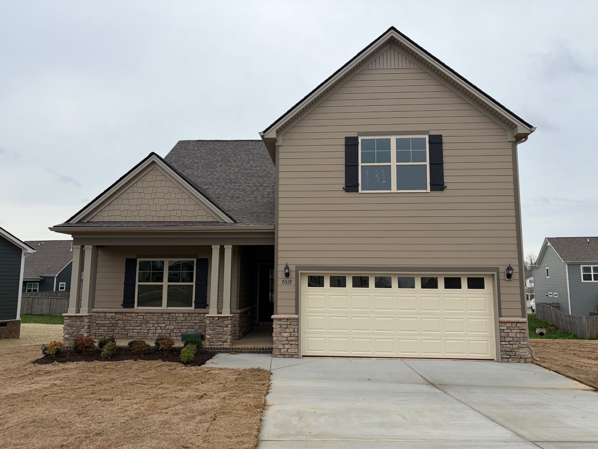 7019 Sully Court Fairview, TN 37062 - Photo 1 of 9 a front view of a house with a yard and garage