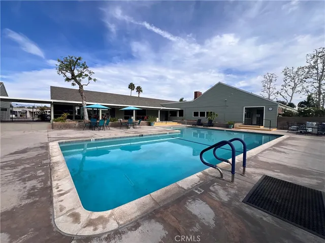 a view of a house with pool patio and a yard