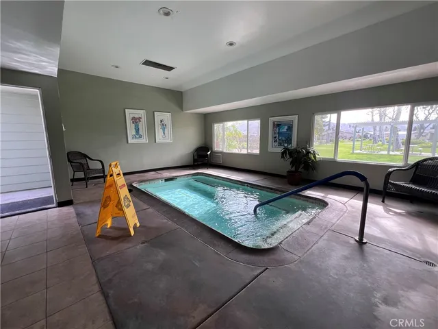 a living room with furniture rug and a large window