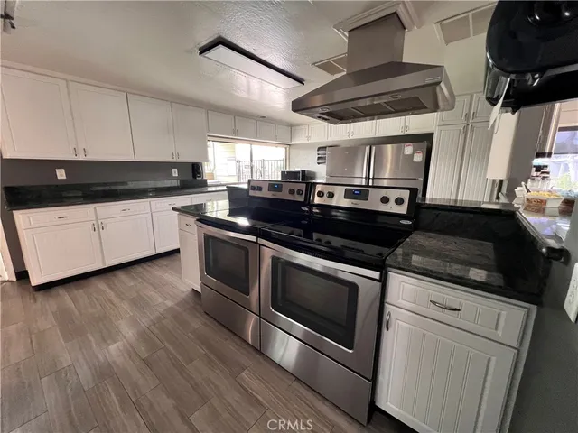 a dining room with furniture and a flat screen tv