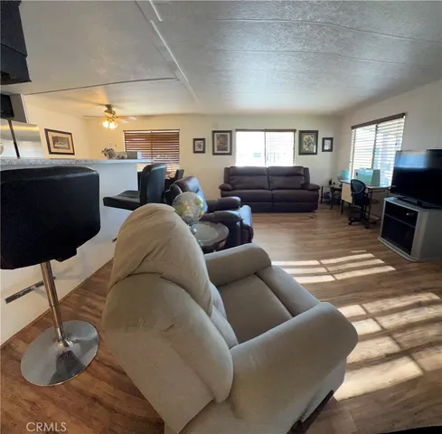 a living room with furniture a window and a flat screen tv
