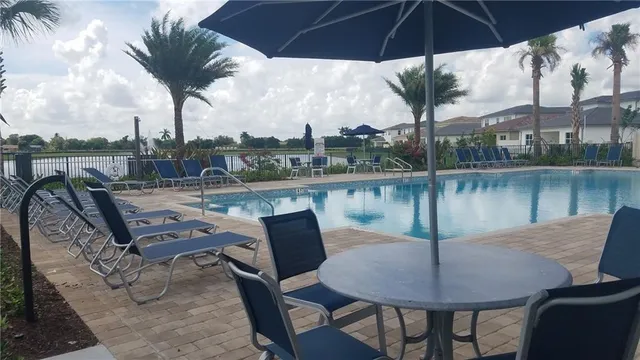 a view of a lake with a table and chairs