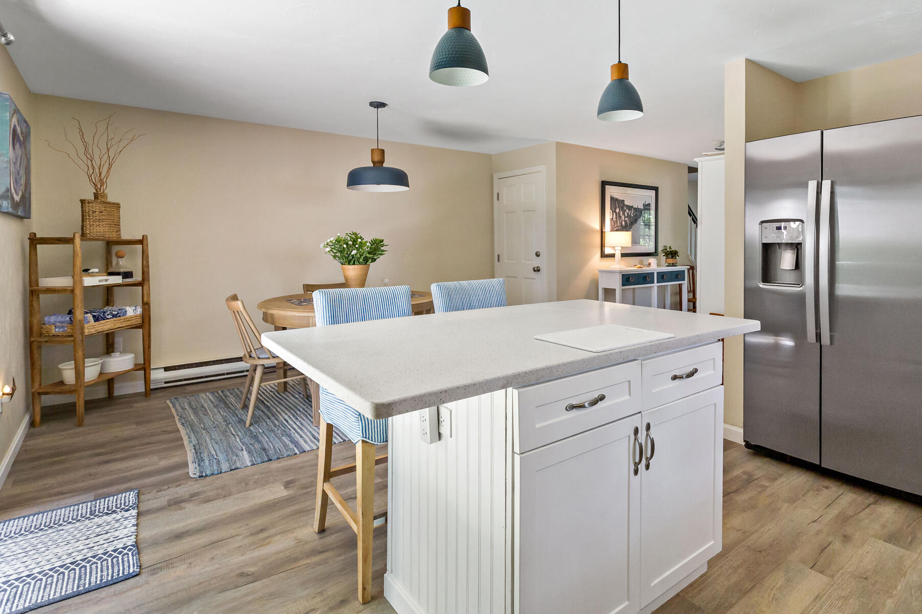 195 Falmouth Road, Unit 16A Mashpee, MA 02649 - Photo 12 of 43 a kitchen that has a table chairs and wooden floor