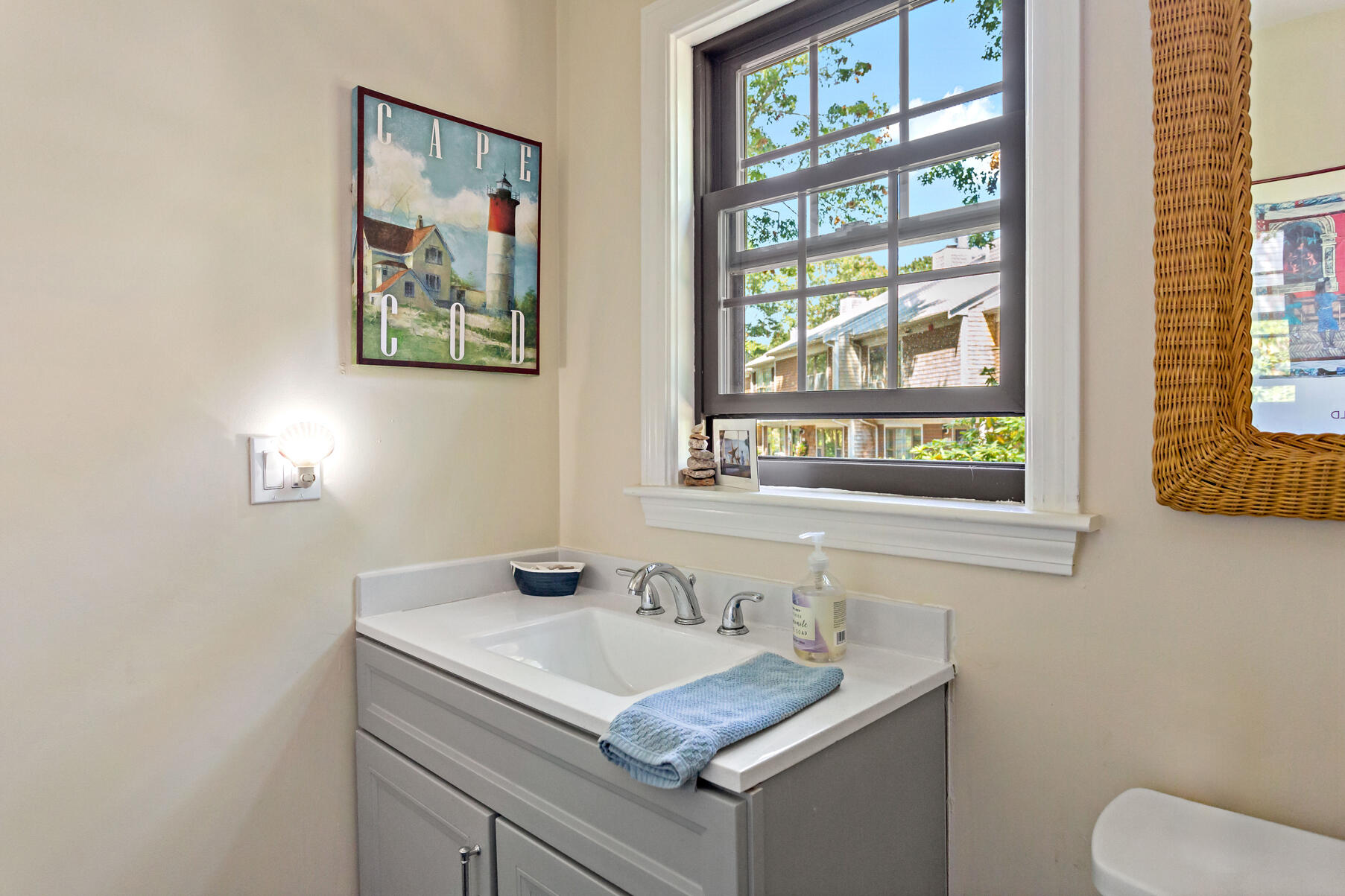 195 Falmouth Road, Unit 16A Mashpee, MA 02649 - Photo 15 of 43 a bathroom with a granite countertop sink a large mirror and a window