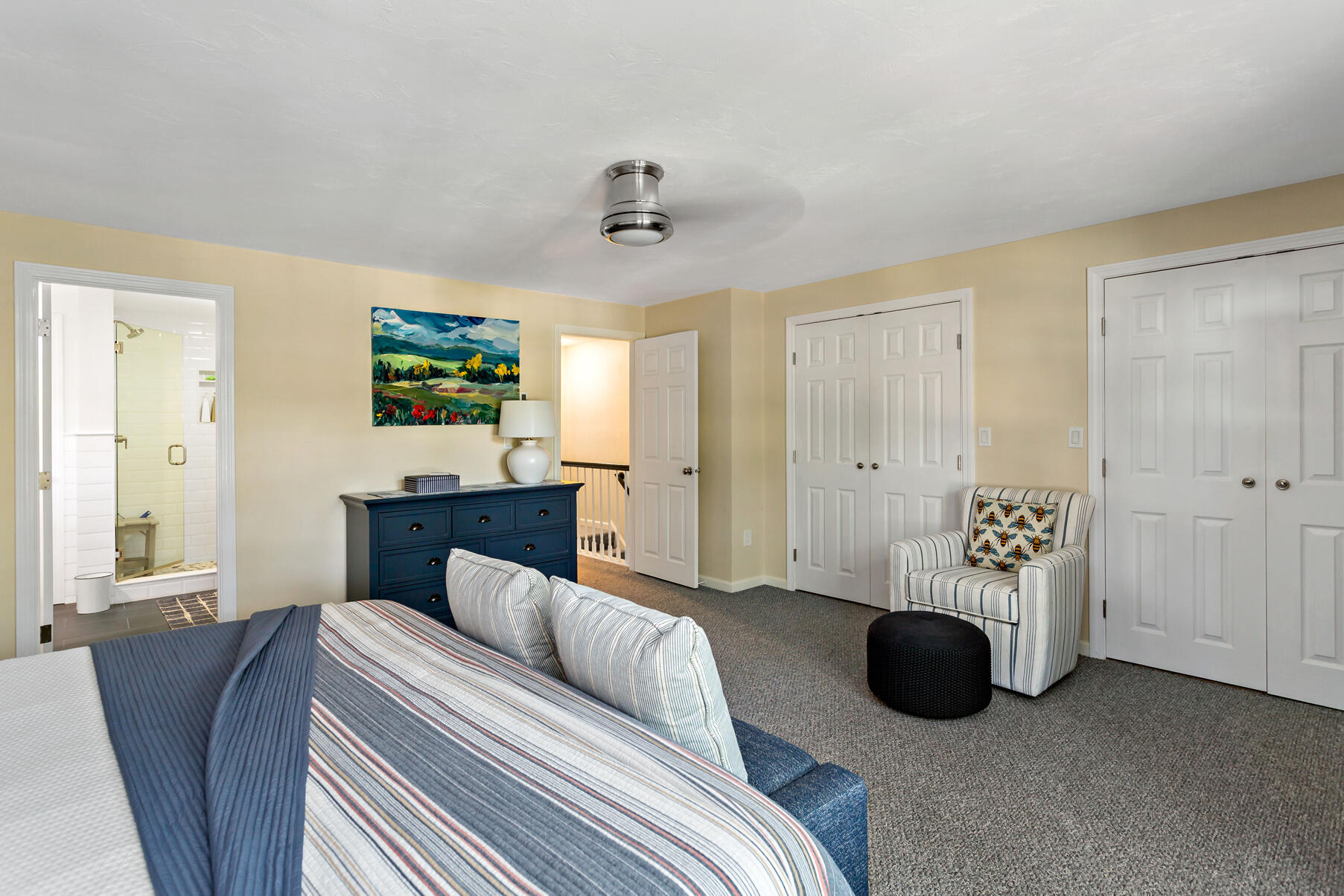 195 Falmouth Road, Unit 16A Mashpee, MA 02649 - Photo 20 of 43 a bedroom with a bed and a chandelier