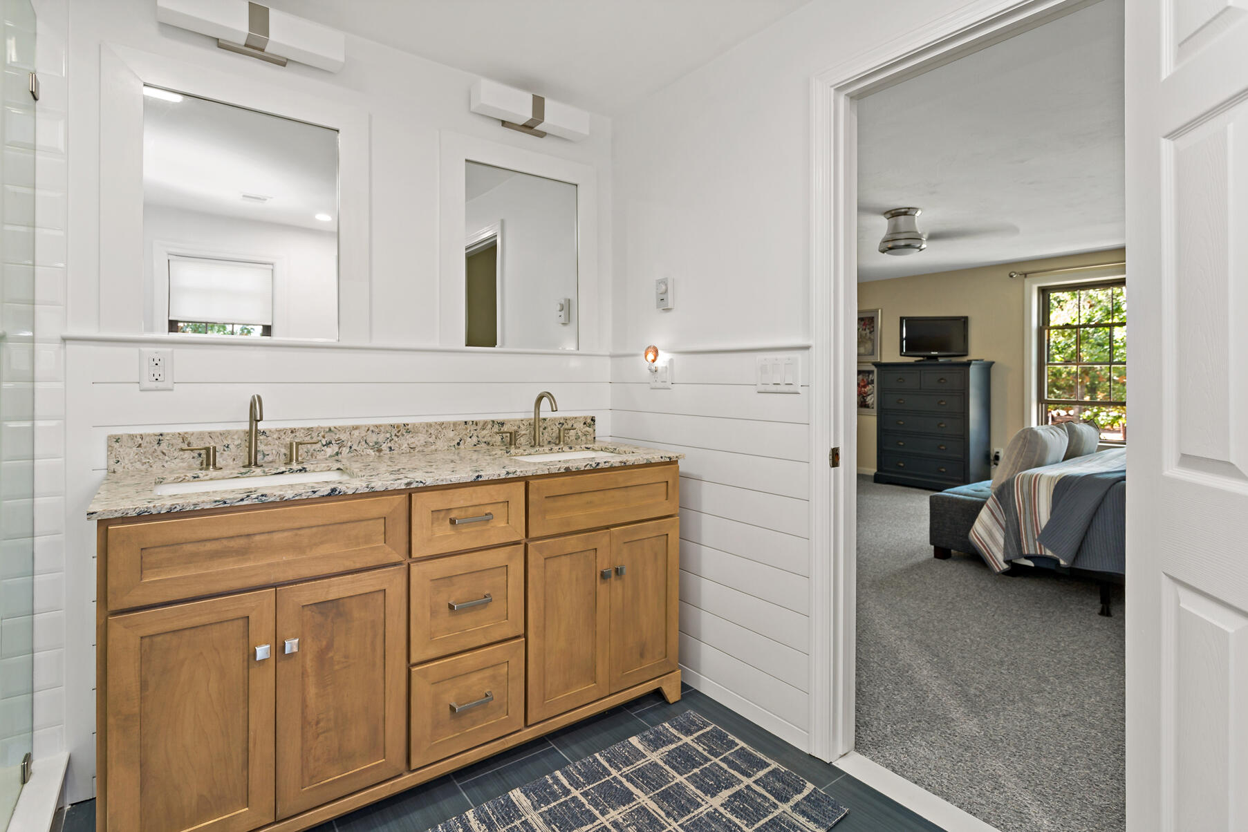 195 Falmouth Road, Unit 16A Mashpee, MA 02649 - Photo 22 of 43 a spacious bathroom with a granite countertop sink and a mirror