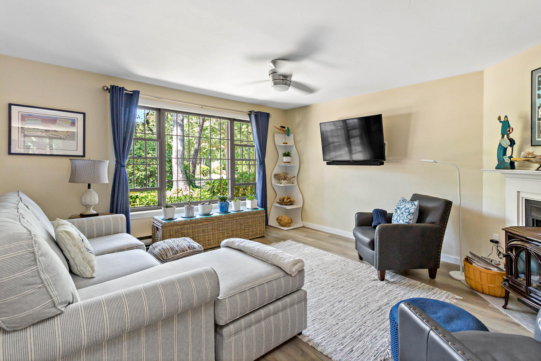 195 Falmouth Road, Unit 16A Mashpee, MA 02649 - Photo 5 of 43 a living room with furniture a flat screen tv and a large window