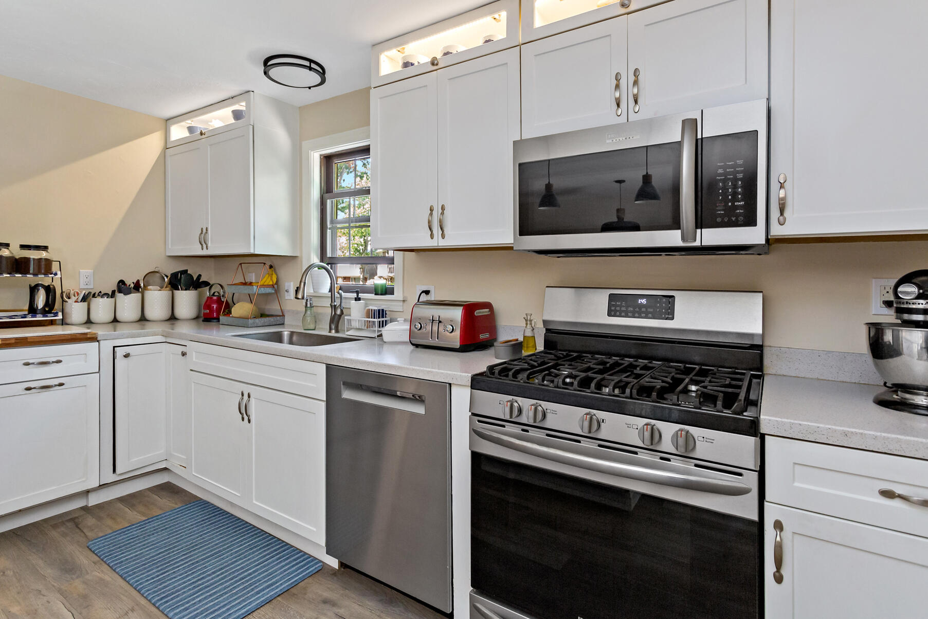 195 Falmouth Road, Unit 16A Mashpee, MA 02649 - Photo 8 of 43 a kitchen with stainless steel appliances granite countertop a sink a stove and microwave