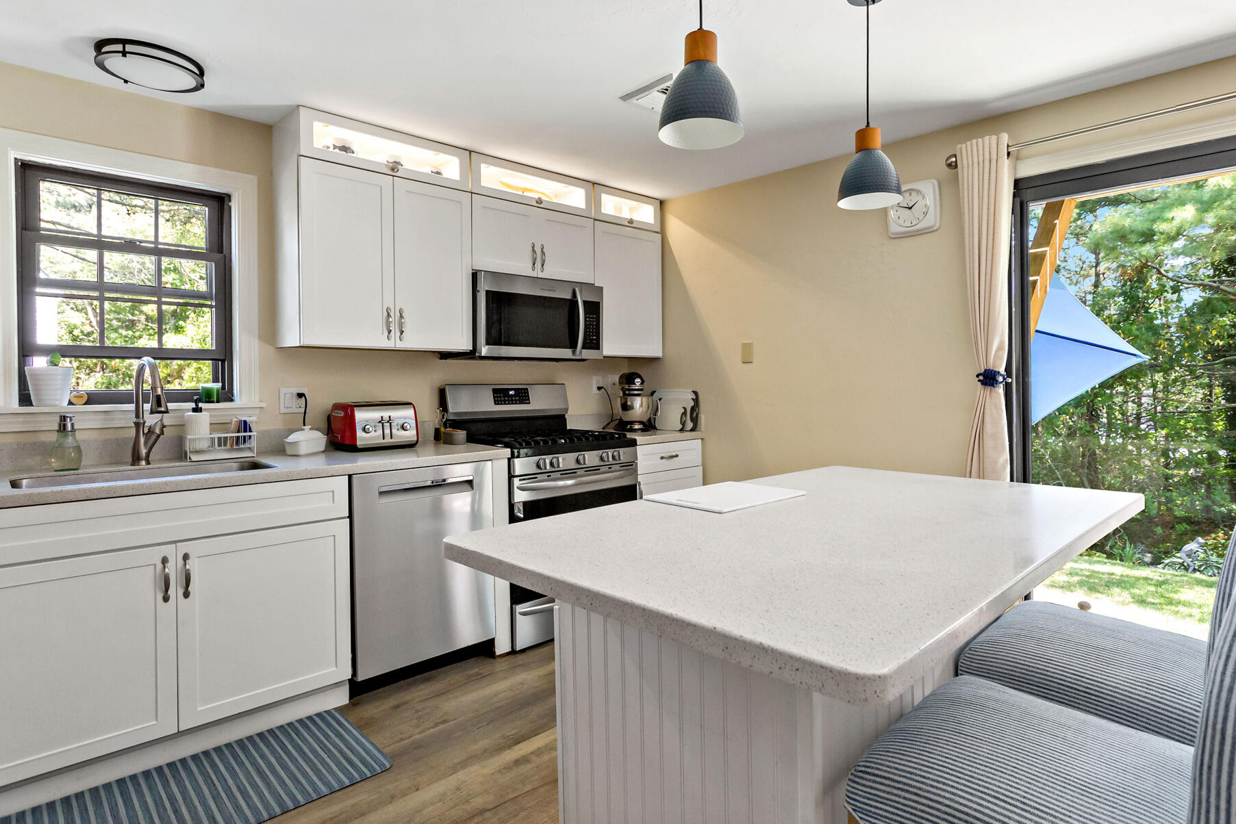 195 Falmouth Road, Unit 16A Mashpee, MA 02649 - Photo 9 of 43 a kitchen with stainless steel appliances a stove a sink a microwave a refrigerator white cabinets and wooden floor