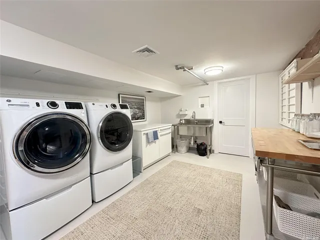 a view of a kitchen with sink washer and dryer