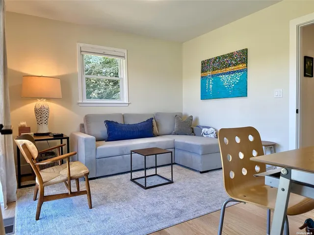 a living room with furniture and a lamp