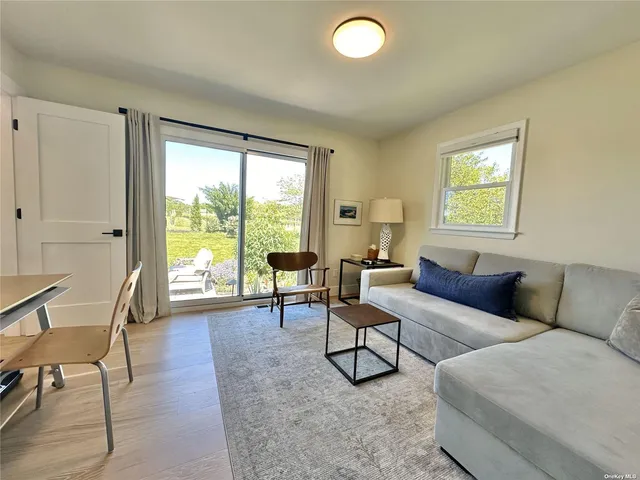 a living room with furniture and a floor to ceiling window