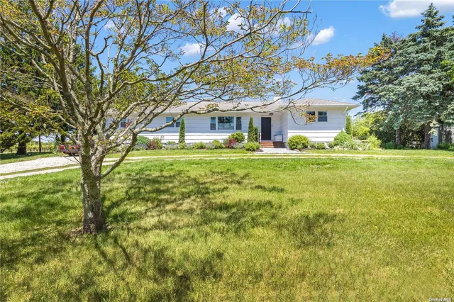 a yellow house in middle of a field