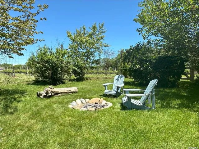 a view of a table and chairs in the garden