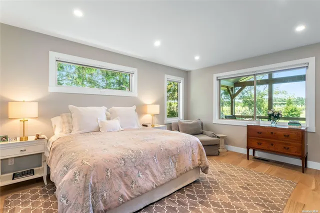 a bedroom with a bed and large window