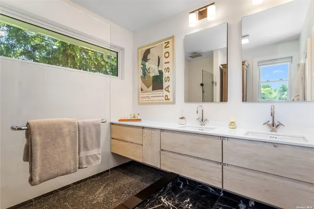 a bathroom with a double vanity sink and mirror