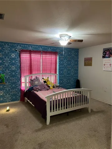 a bed sitting in a room next to a window