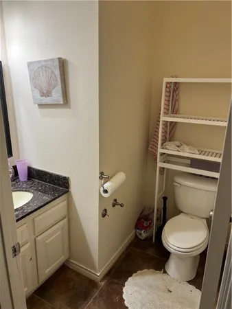 a white toilet sitting next to a bathroom sink