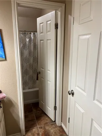 a bathroom with a tub and shower