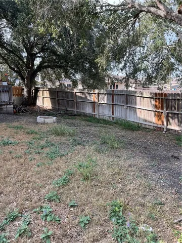 a view of a backyard with large trees