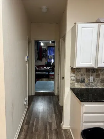 a view of a hallway and wooden floor