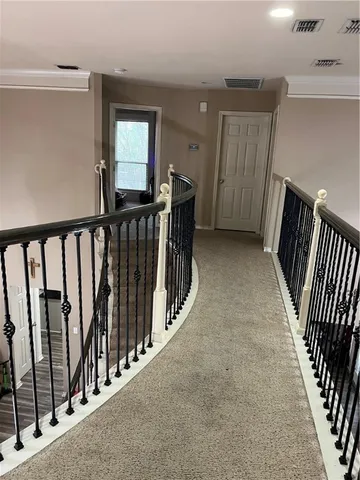 a view of a hallway with entryway to stairs