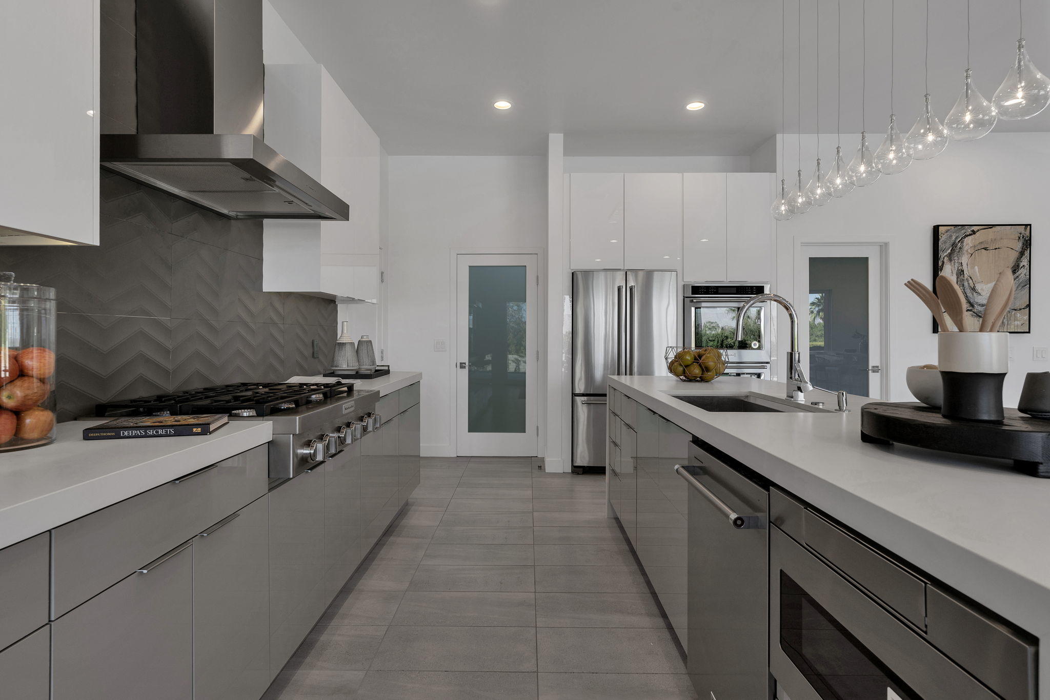 71374 Biskra Road Rancho Mirage, CA 92270 - Photo 11 of 75 a large kitchen with stainless steel appliances granite countertop a stove a sink and a refrigerator