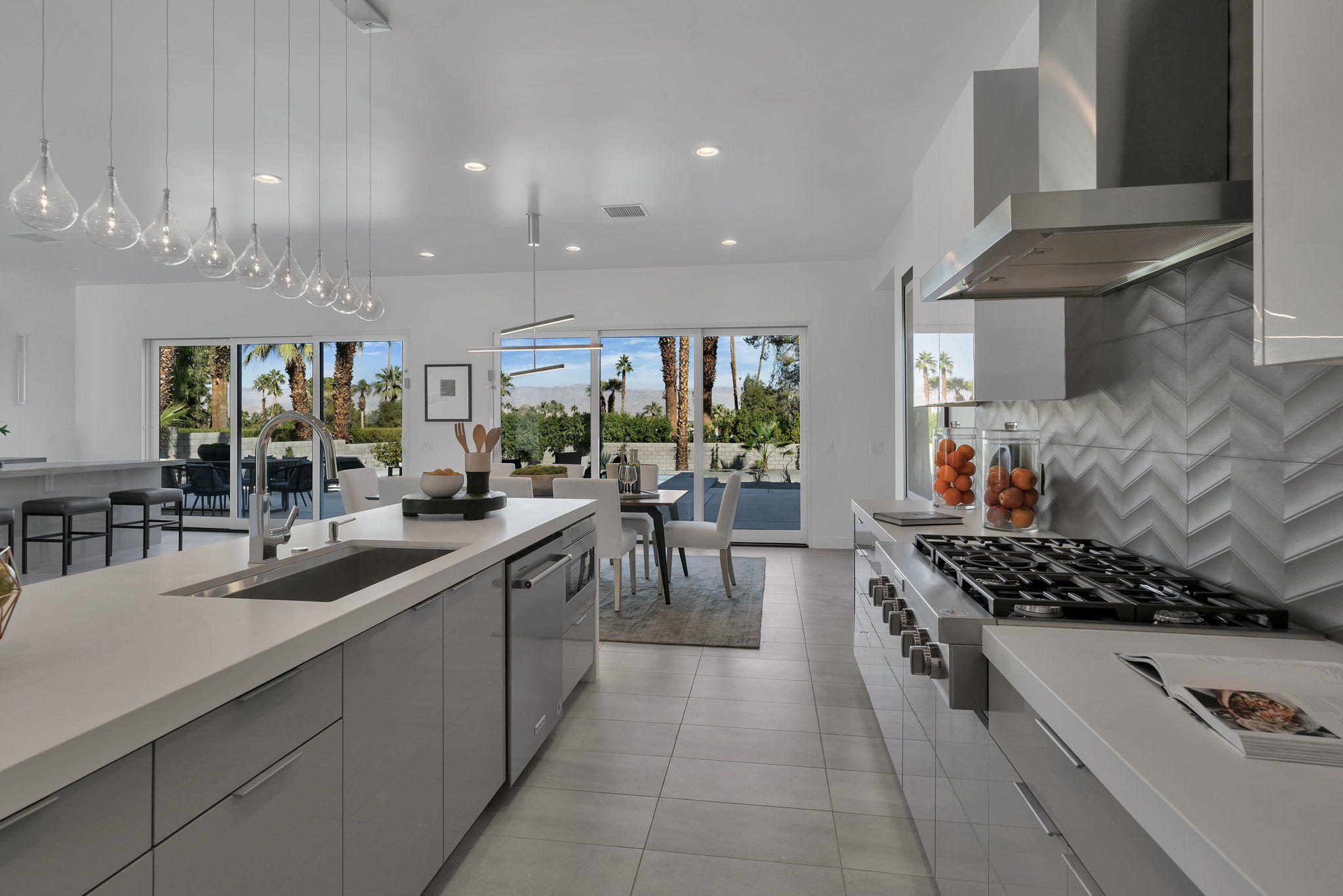 71374 Biskra Road Rancho Mirage, CA 92270 - Photo 17 of 75 a kitchen with stainless steel appliances a sink and a stove