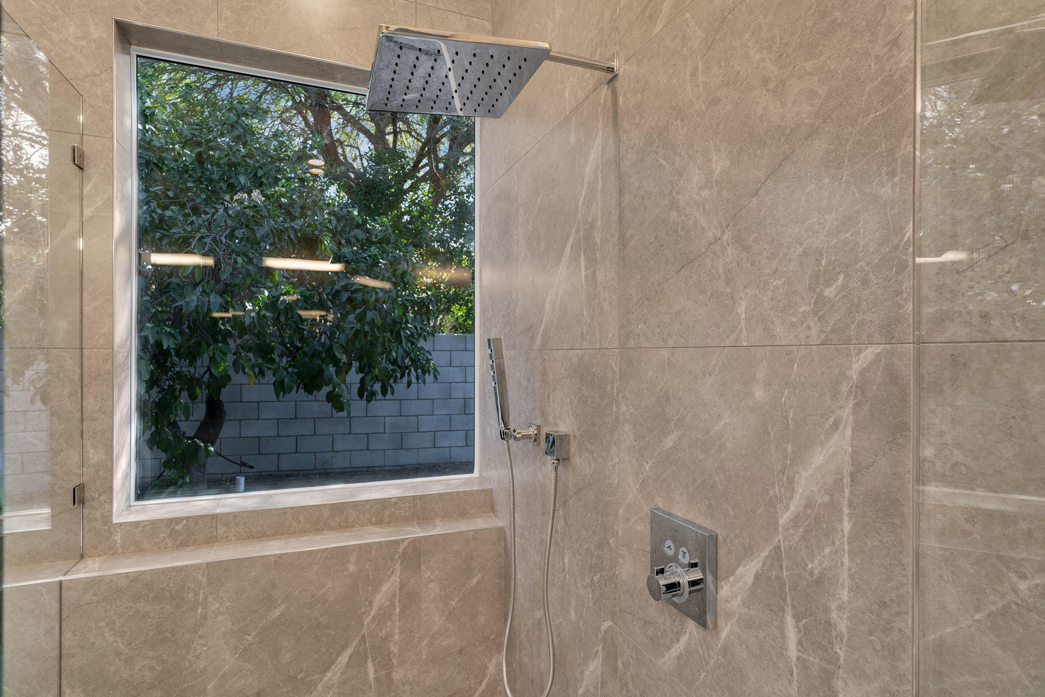 71374 Biskra Road Rancho Mirage, CA 92270 - Photo 30 of 75 a bathroom with a glass shower door