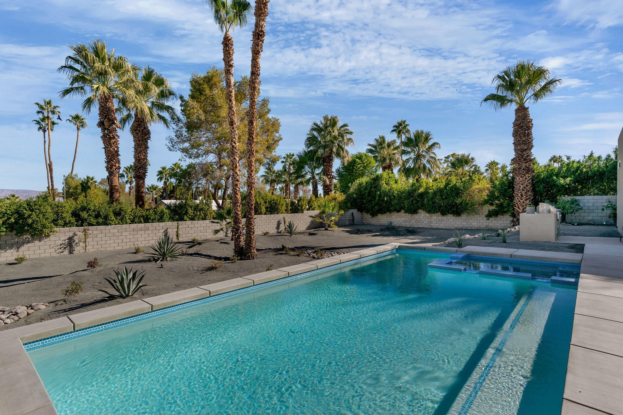 71374 Biskra Road Rancho Mirage, CA 92270 - Photo 36 of 75 a view of a swimming pool with a patio and a garden