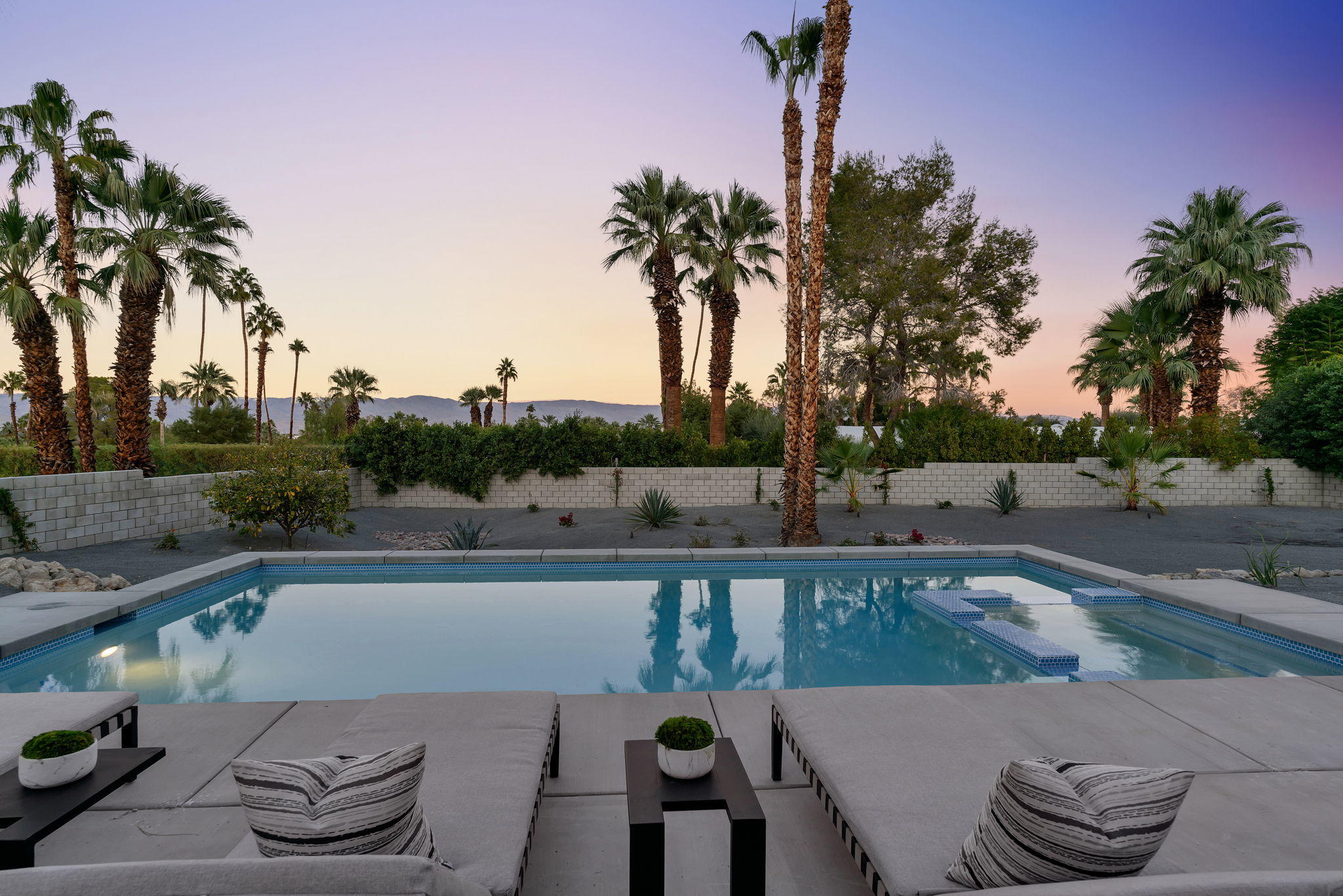 71374 Biskra Road Rancho Mirage, CA 92270 - Photo 66 of 75 a view of a patio with couches and table and chairs under an umbrella