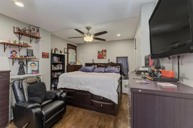 a bed room with furniture and a flat screen tv
