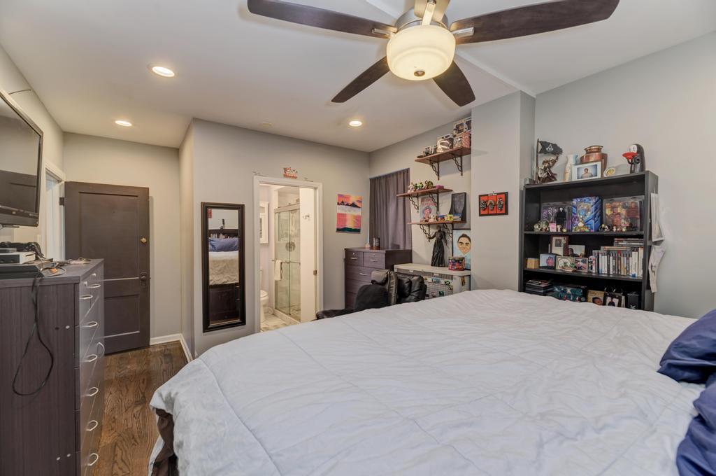 1941 North Harding Avenue Chicago, IL 60647 - Photo 15 of 44 a large bedroom with bed and a chandelier