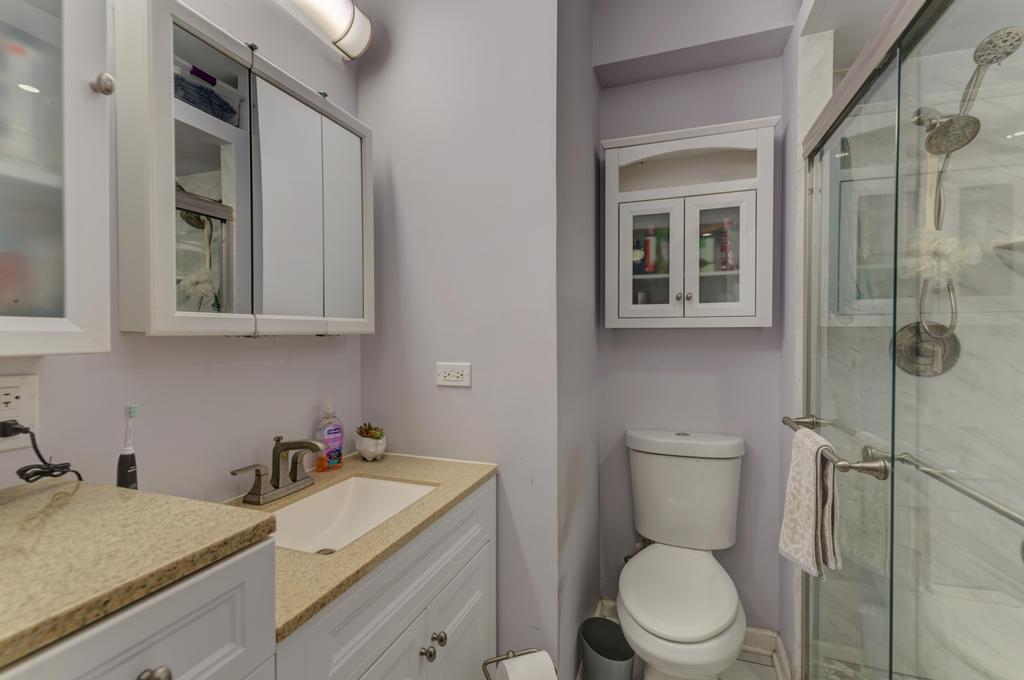 1941 North Harding Avenue Chicago, IL 60647 - Photo 16 of 44 a bathroom with a sink toilet vanity and tub