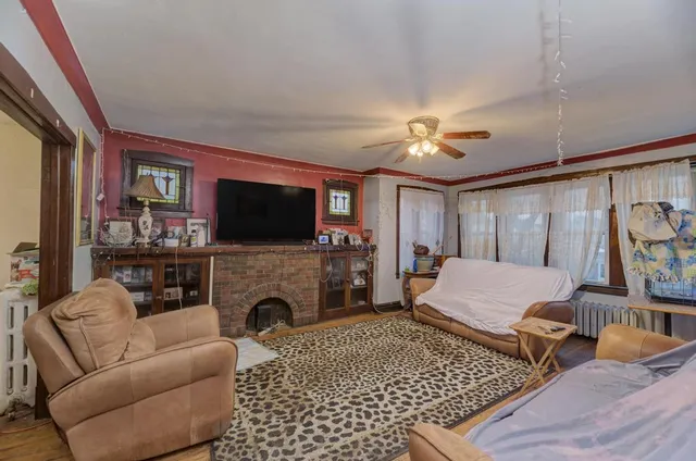 a living room with furniture a flat screen tv and a fireplace