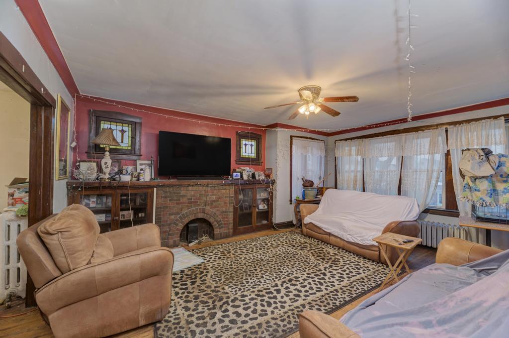 1941 North Harding Avenue Chicago, IL 60647 - Photo 23 of 44 a living room with furniture a flat screen tv and a fireplace