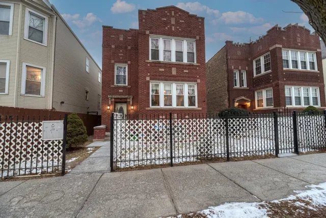 a front view of a brick building with many windows