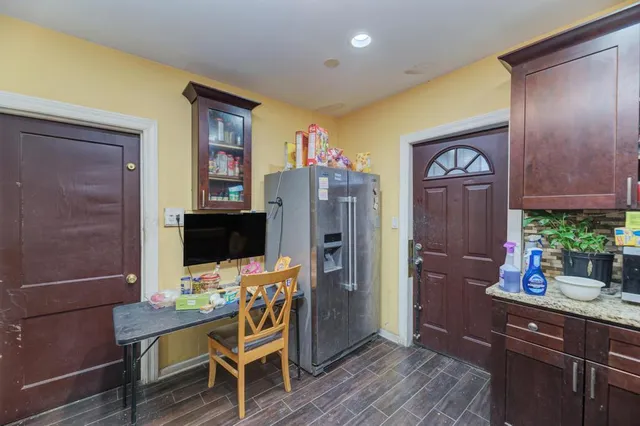 a view of a workspace with furniture and wooden floor