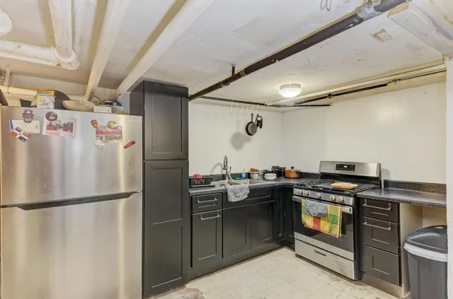 a kitchen with stainless steel appliances a refrigerator and a stove