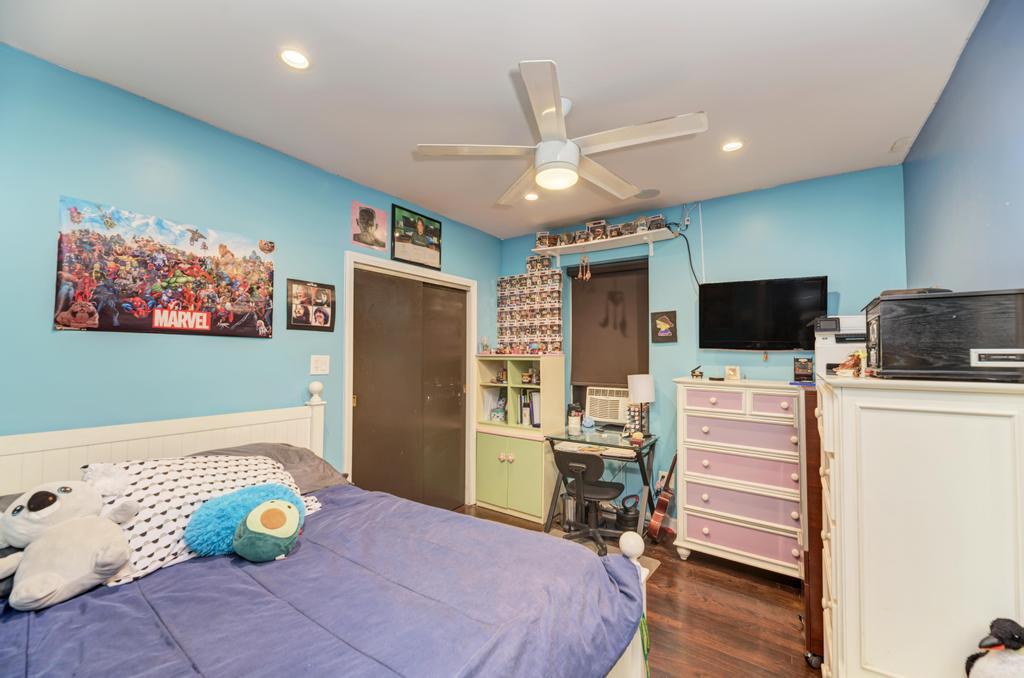 1941 North Harding Avenue Chicago, IL 60647 - Photo 10 of 44 a bedroom with a bed and flat screen tv