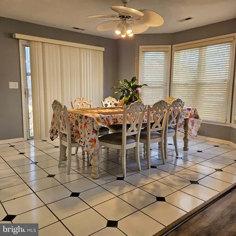 a view of a dining room with furniture and chandelier