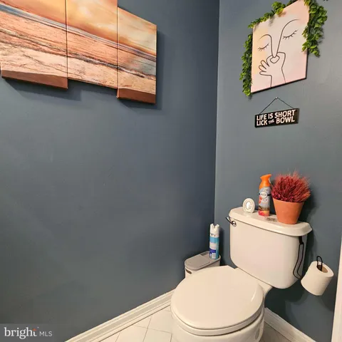a white toilet sitting next to a bathroom sink