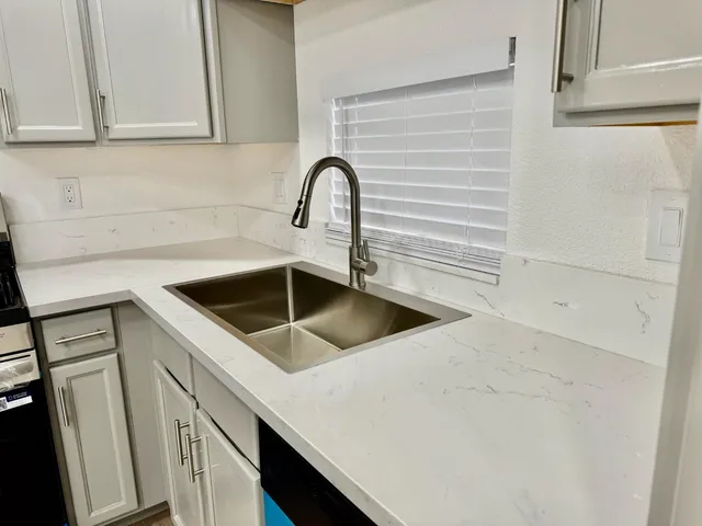 a view of a kitchen with sink and washing machine