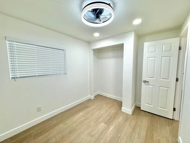 an empty room with wooden floor